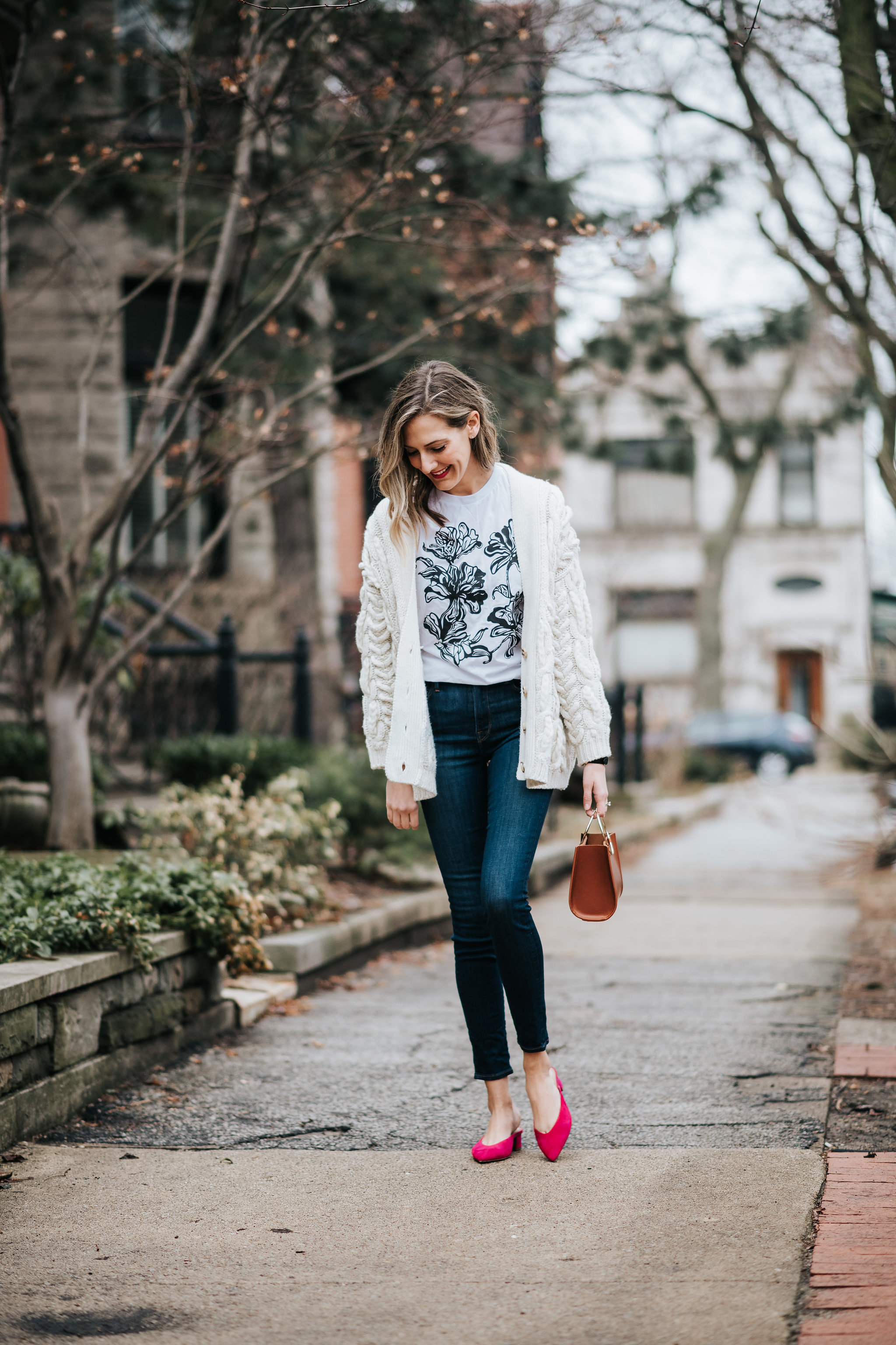 how to wear graphic tees in an outfit with jeans and a sweater