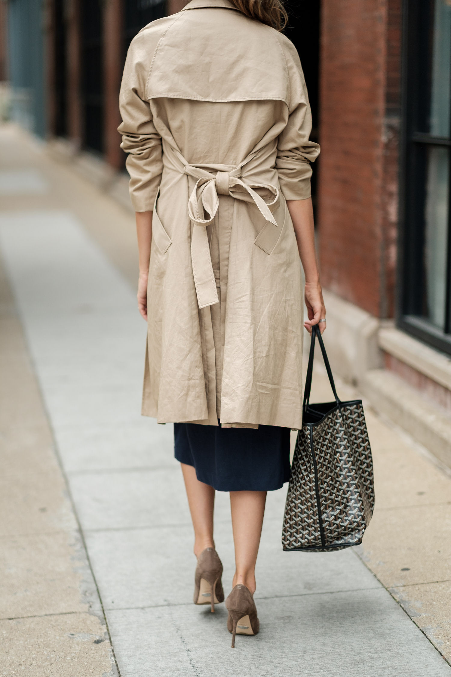 back details of a woman's trench coat