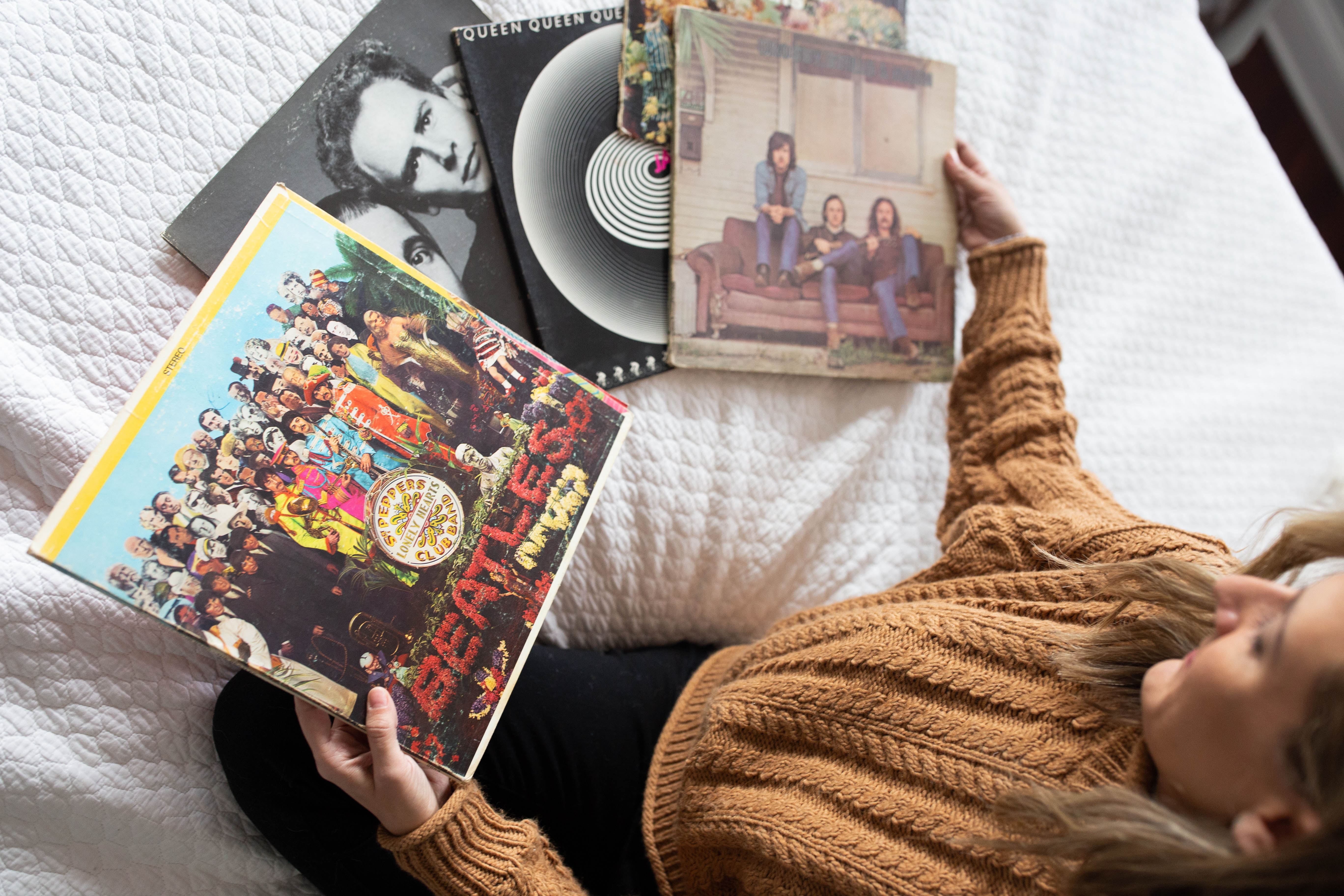 woman showing her old vinyl records