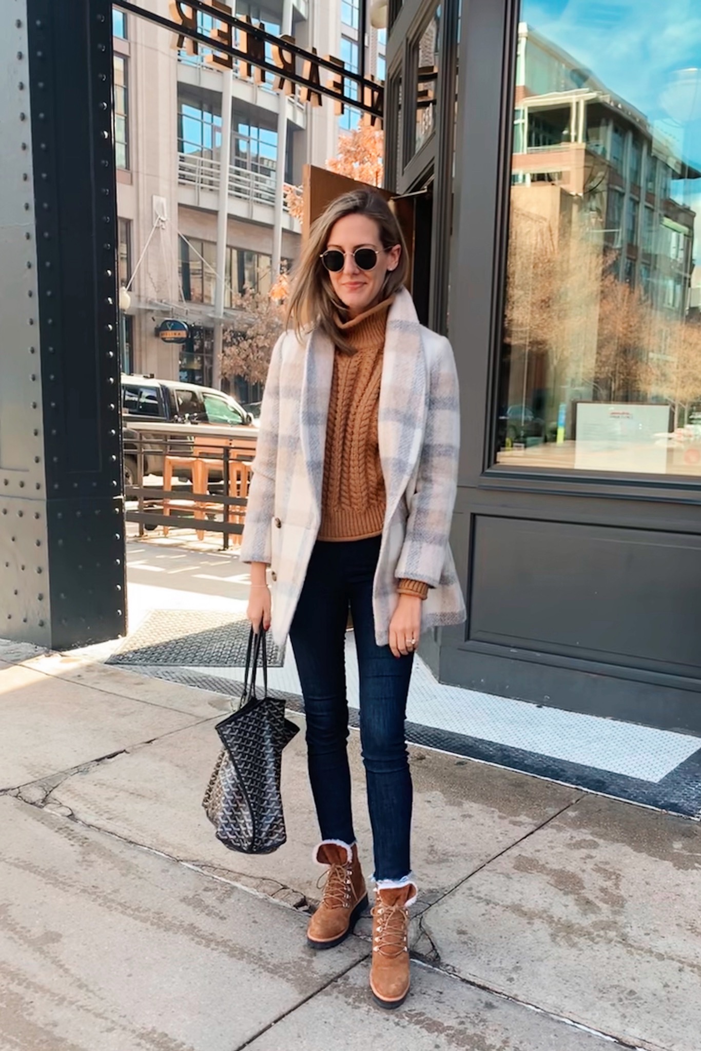 woman sharing her Real outfit recap Date Nights in coat, brown top, and jeans