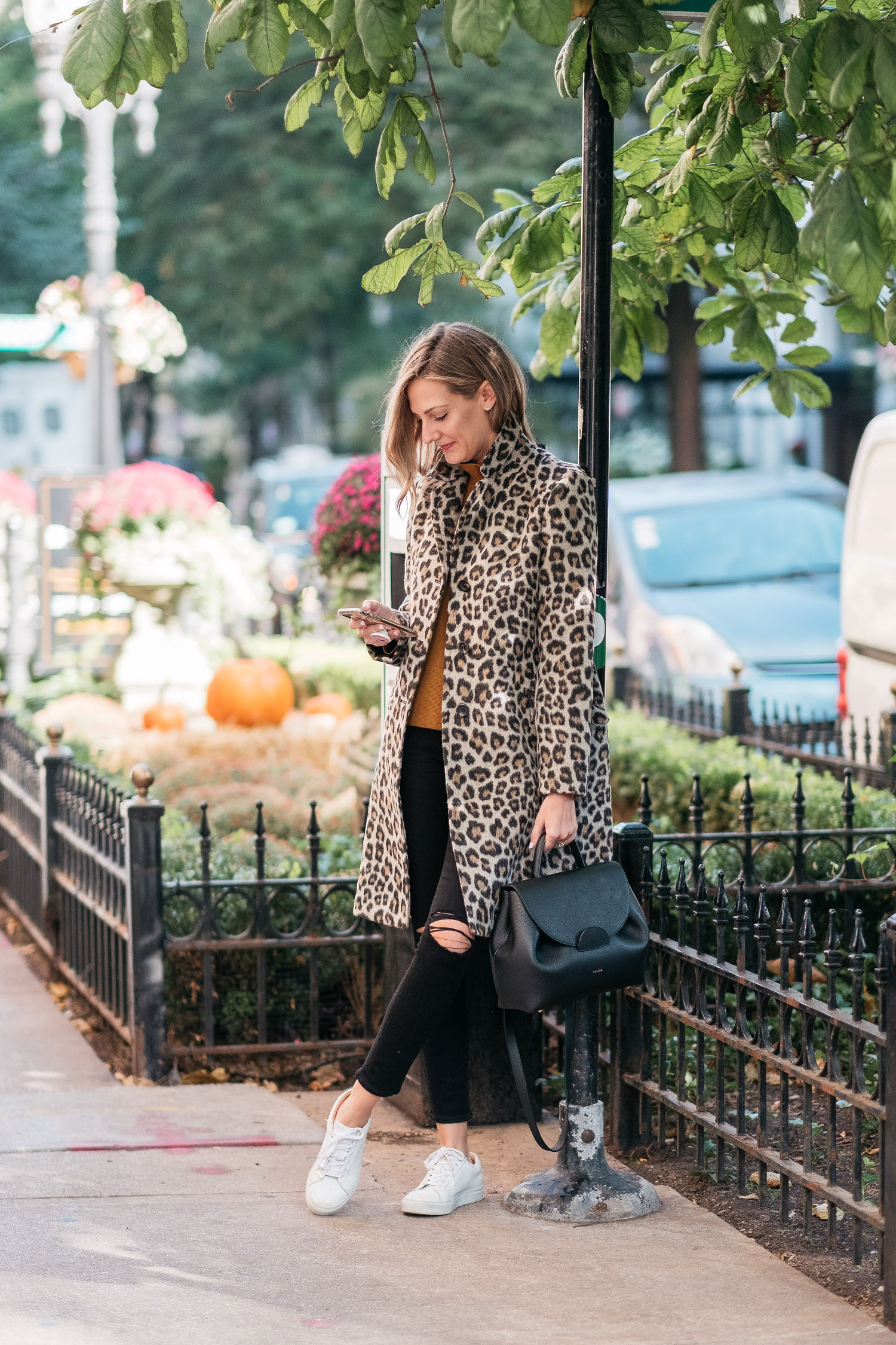 woman wearing animal print jacket, orange shirt, and black pants and sharing her Thoughts On Turning 35