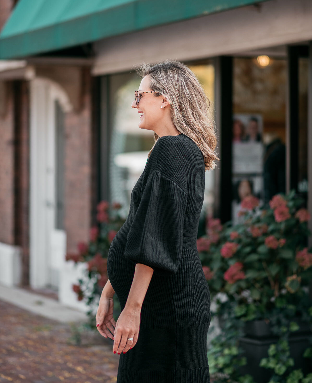 woman wearing black dress from Saks friends family sale