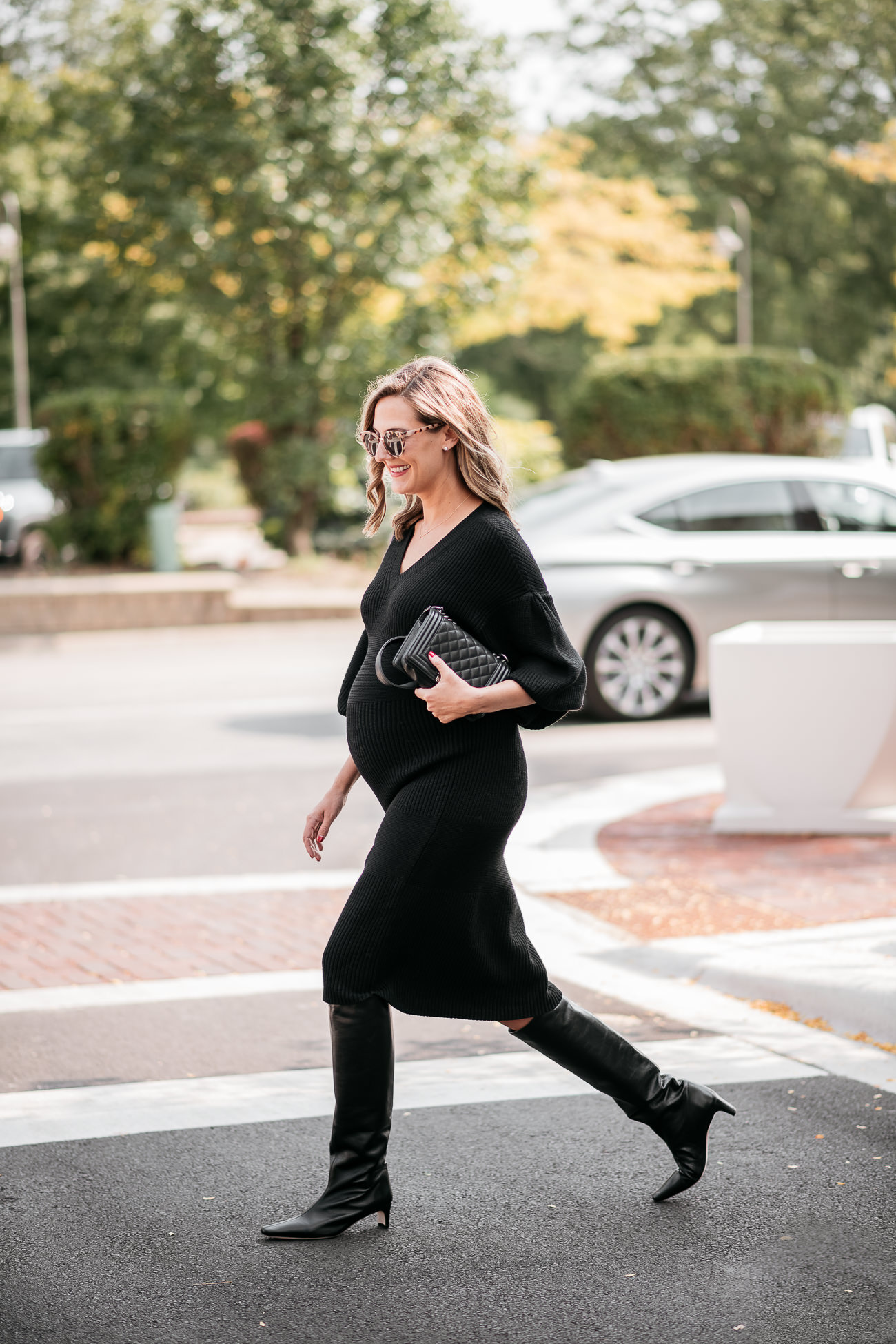 woman wearing black dress and boots from Saks friends family sale