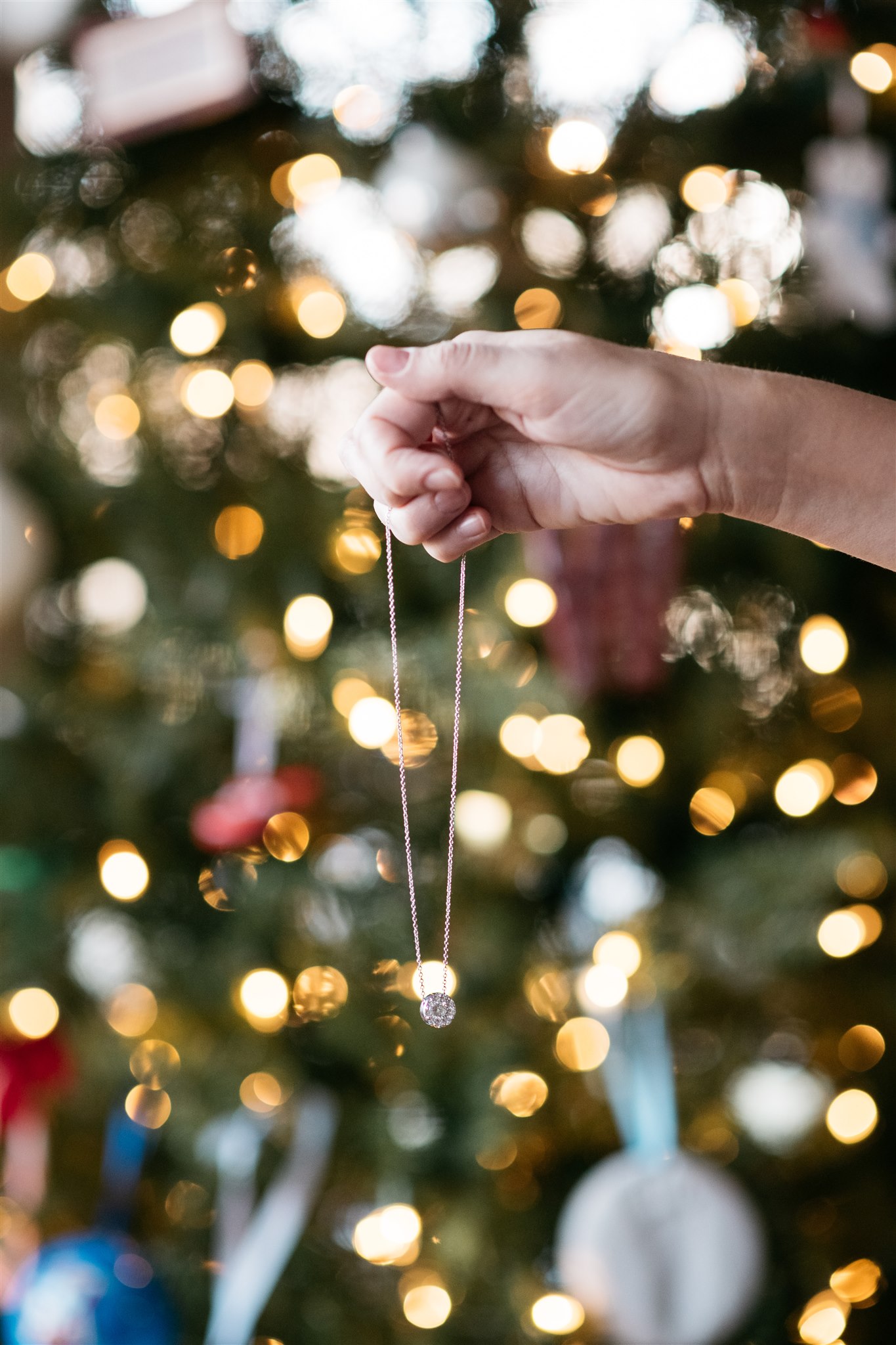 woman holding a necklace to show how to Add Some Sparkle