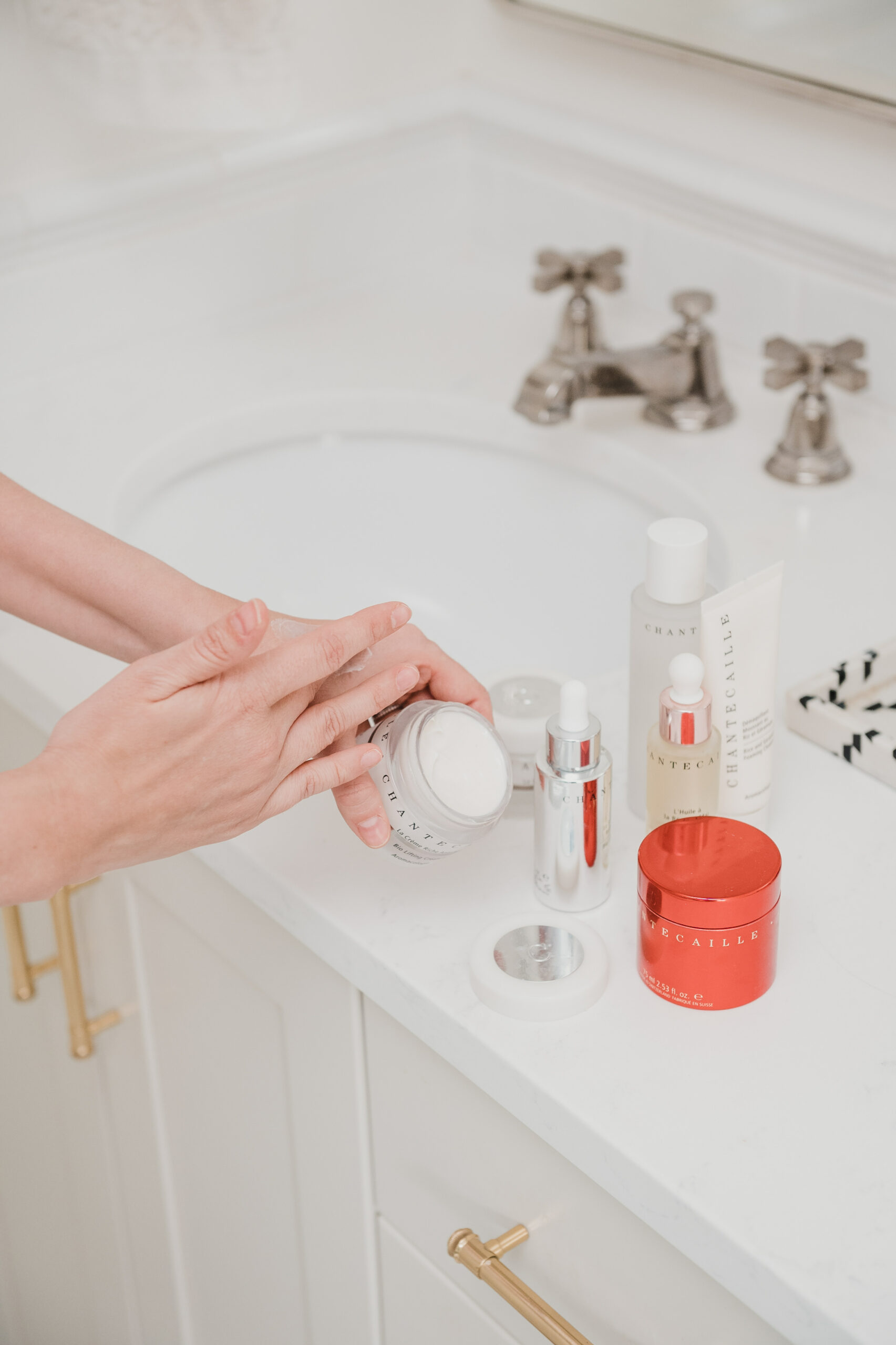 woman applying product on her hand for Chantecaille Skincare Review