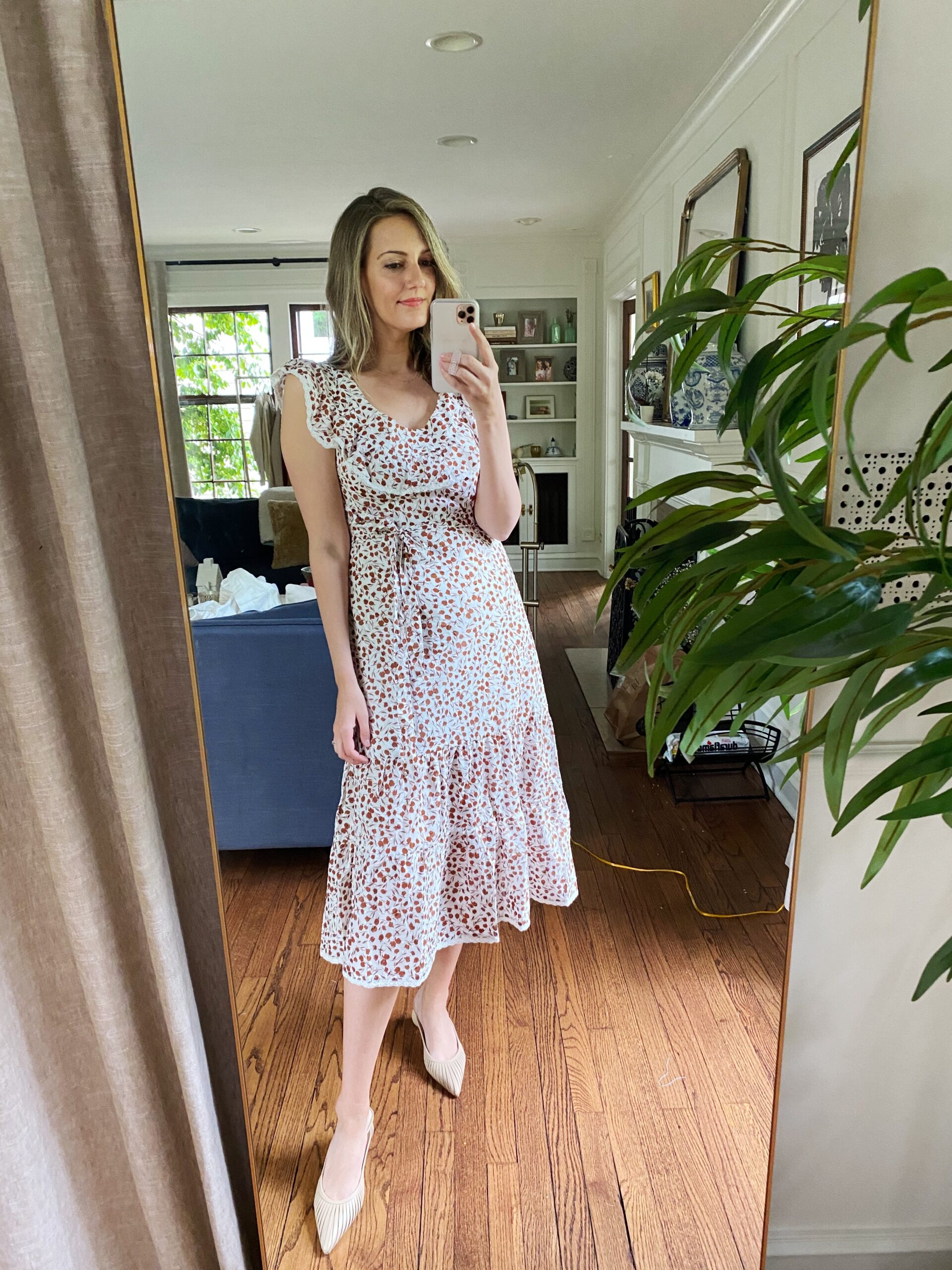 Target Rixo Dress on a woman taking a selfie in her living room 