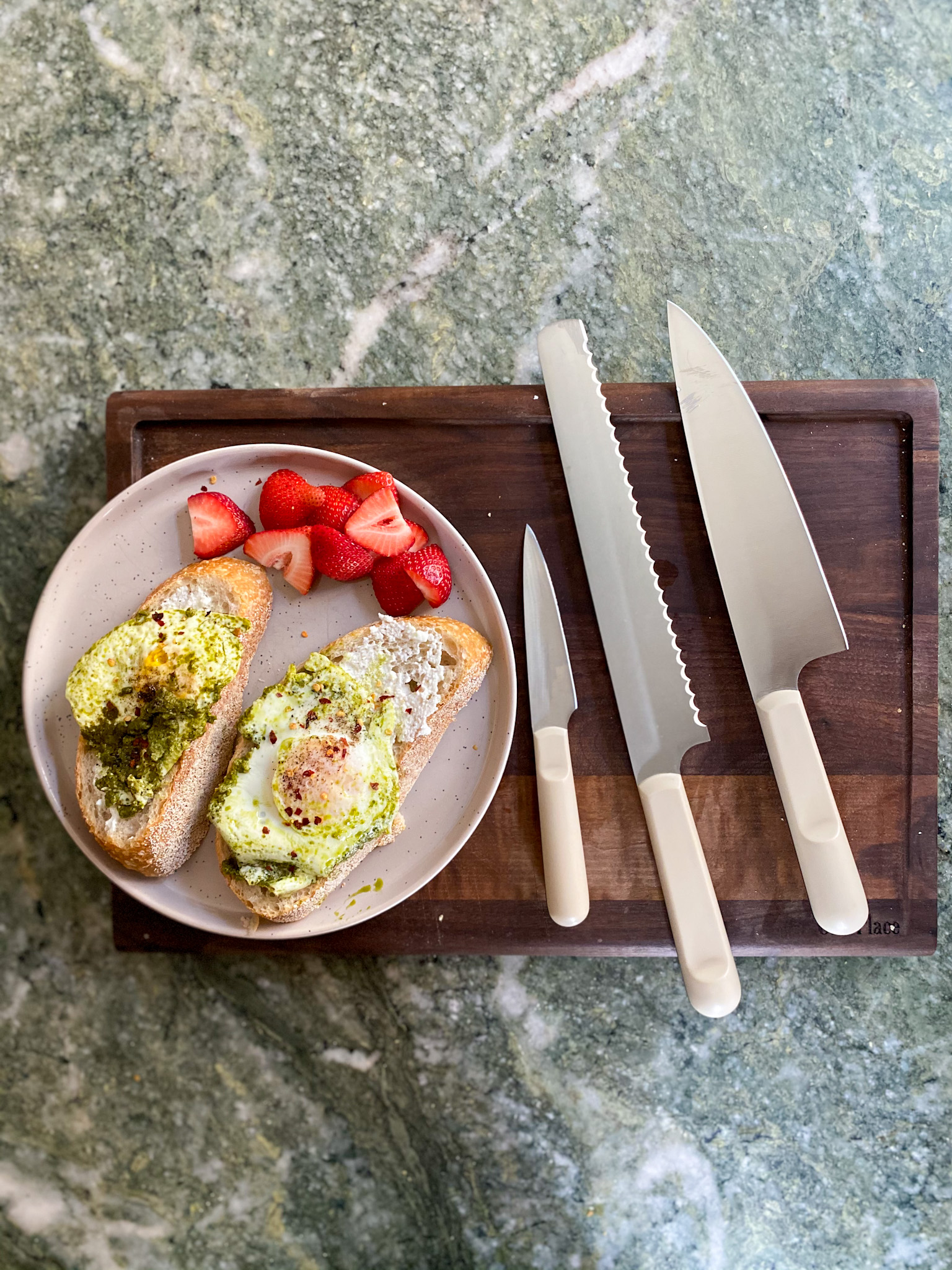 Our Place Knives Review on a chopping board and plate with food