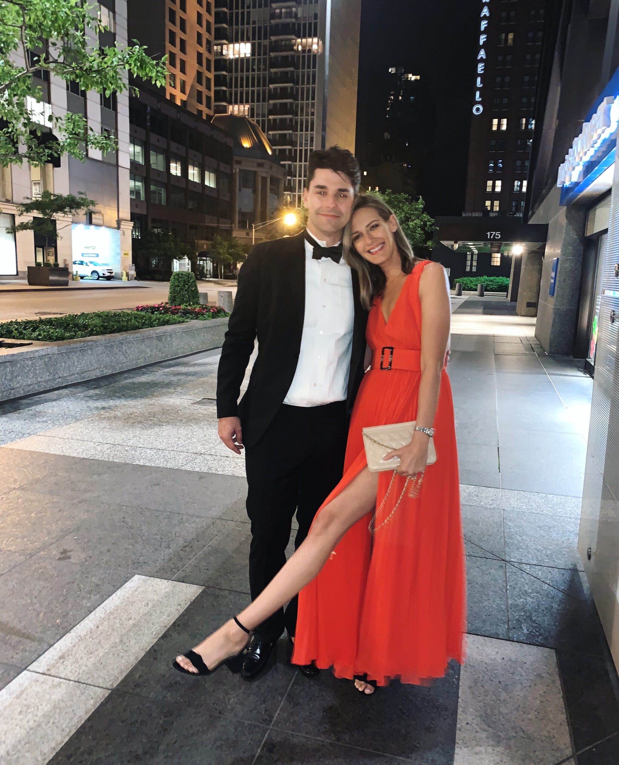 woman with Wedding Guest Dresses in red and man in a tuxedo