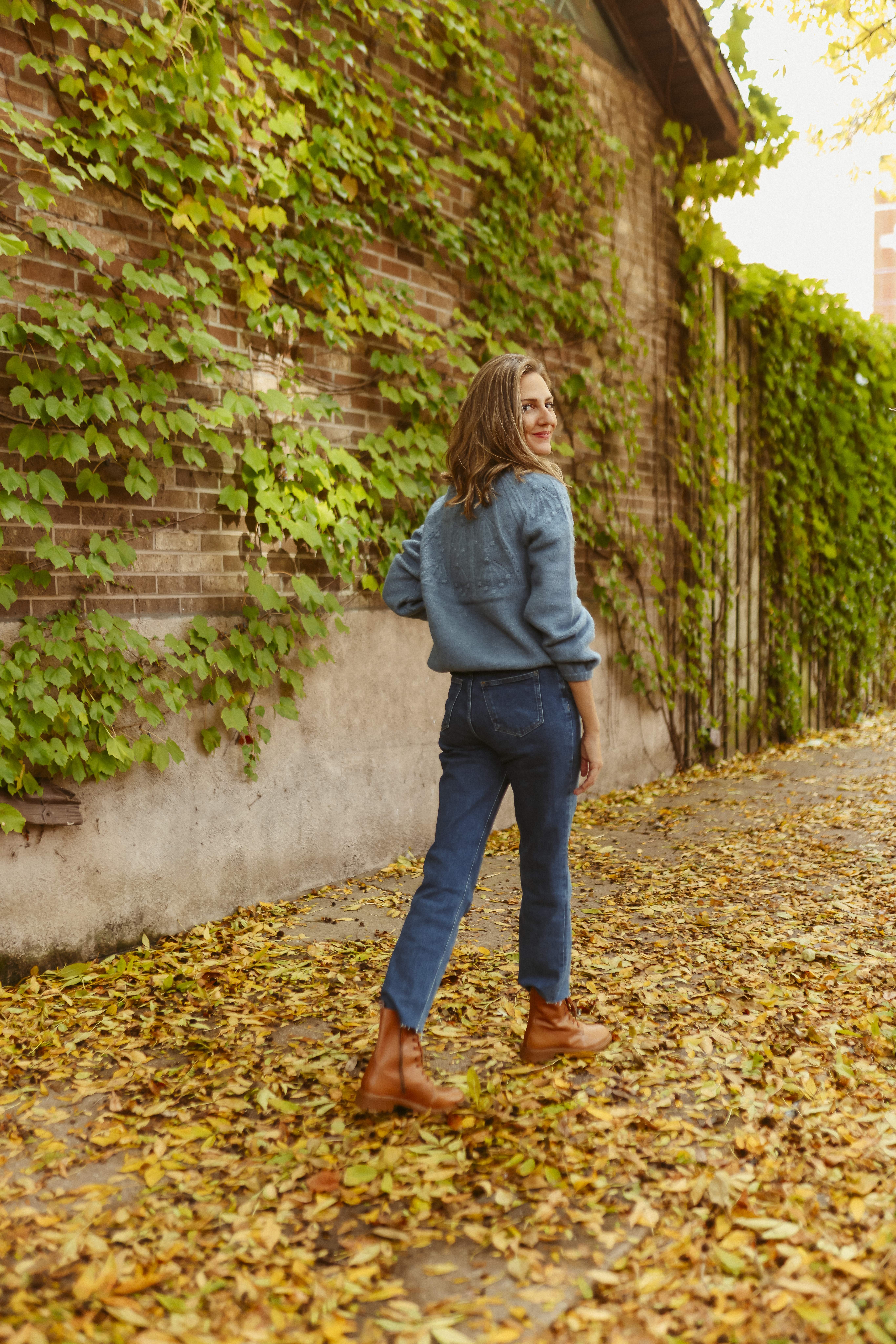 woman in blue sweater and jeans for Holiday Style with Boden