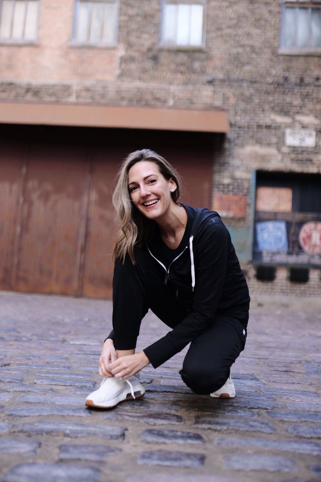 woman tying her shoelace for Vuori Review