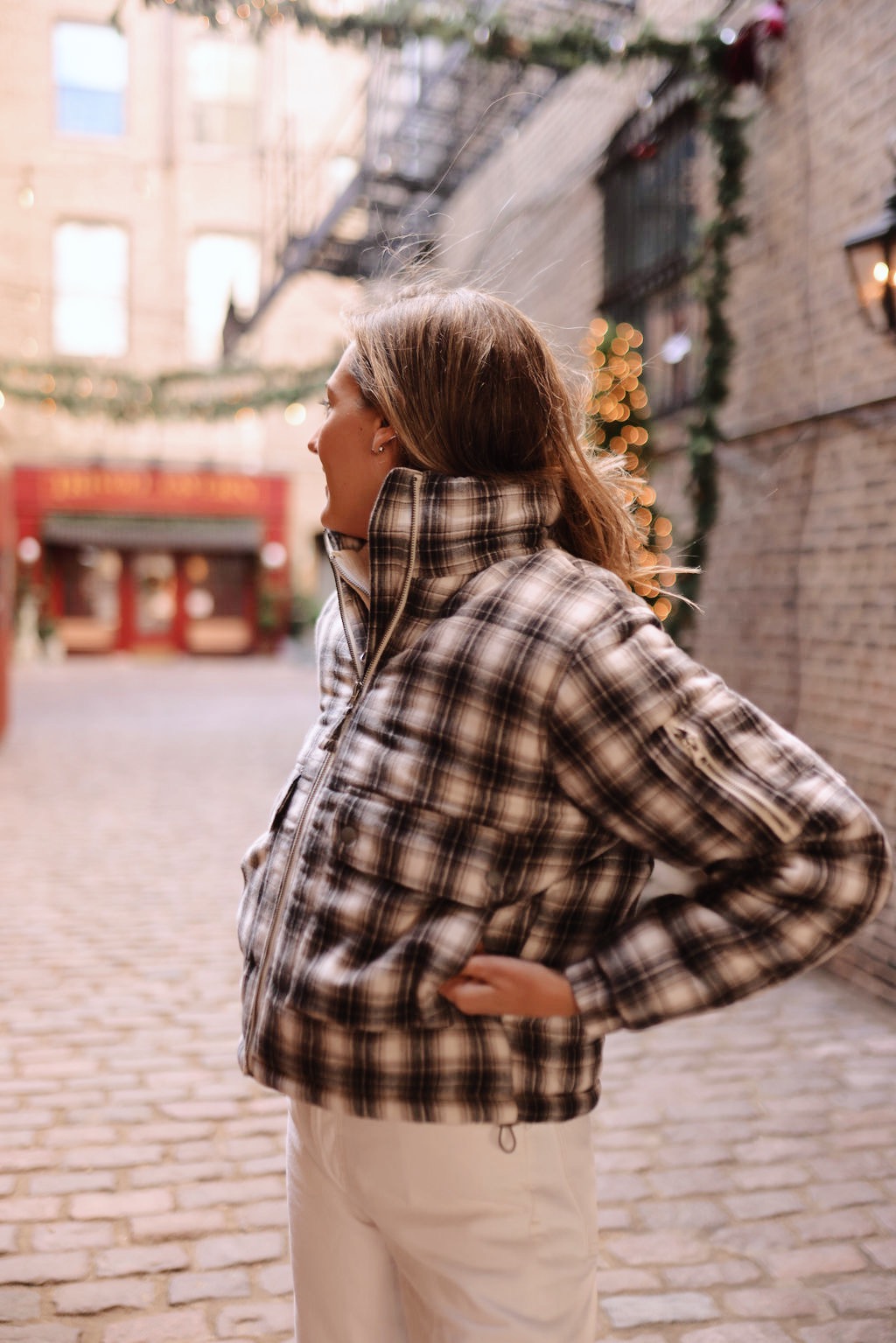 woman in sweater and sharing Holiday Gifting with Urban Outfitters