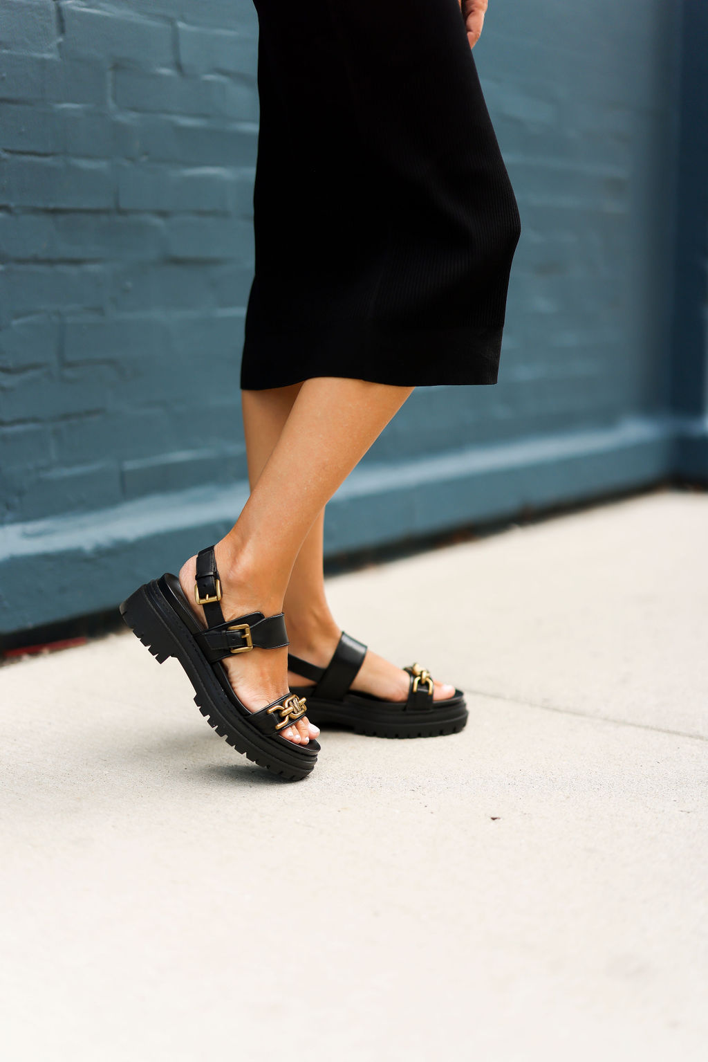 woman in black Michael Kors platform sandals