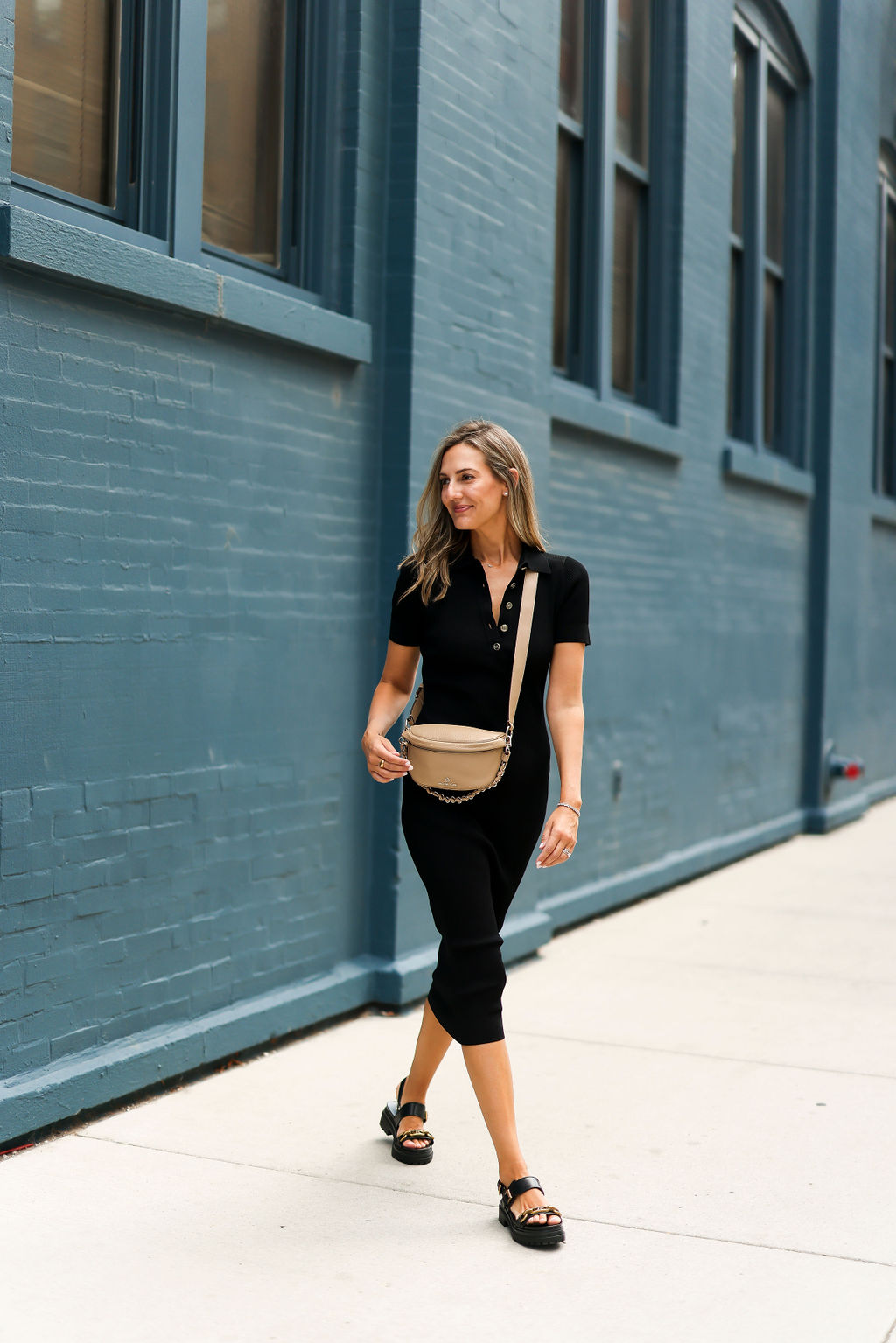 woman in black Michael Kors dress and bag