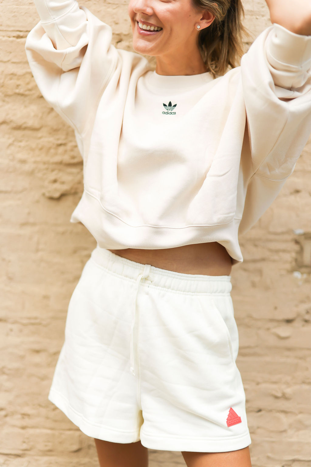 woman smiling and wearing adidas clothes