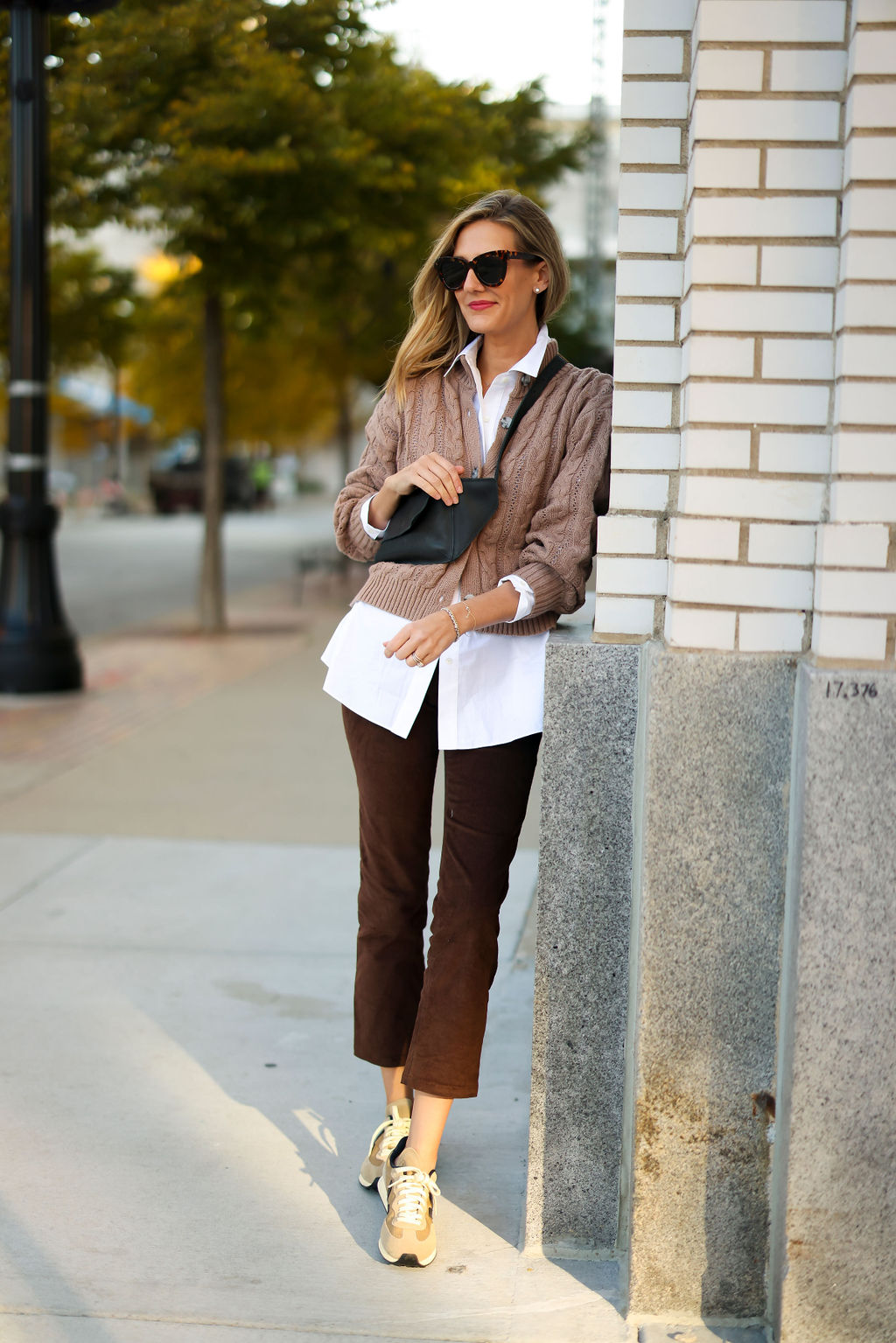 woman wearing sweater, button down top, and pants from ABLE