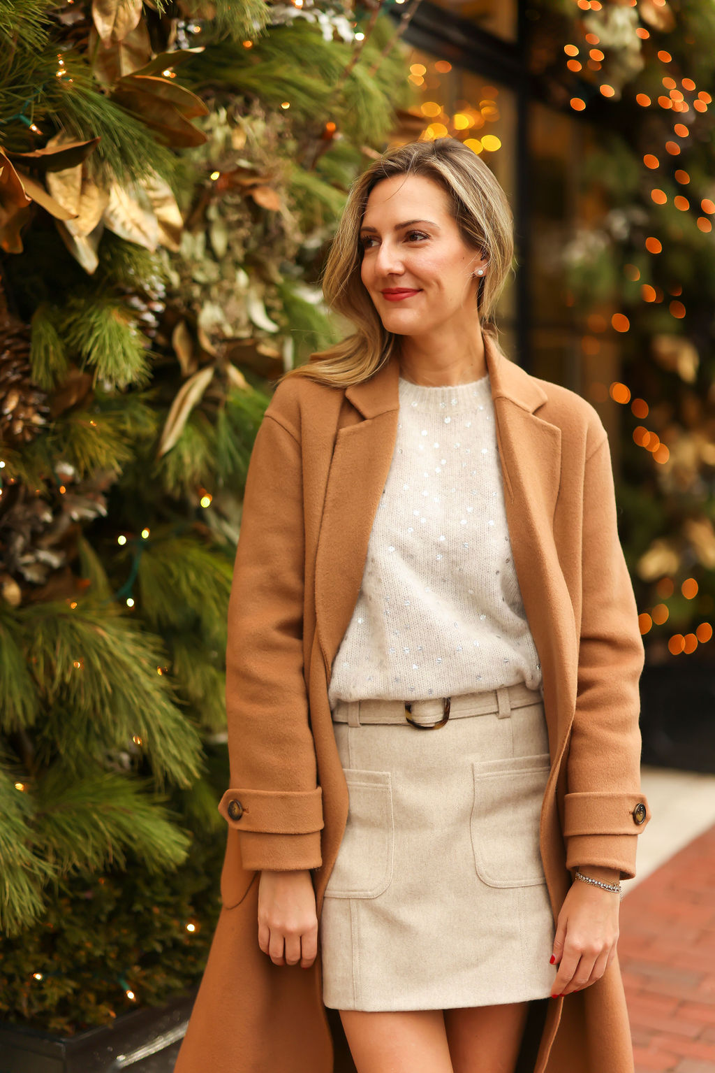 woman wearing glitter top, skirt, and coat from Sézane