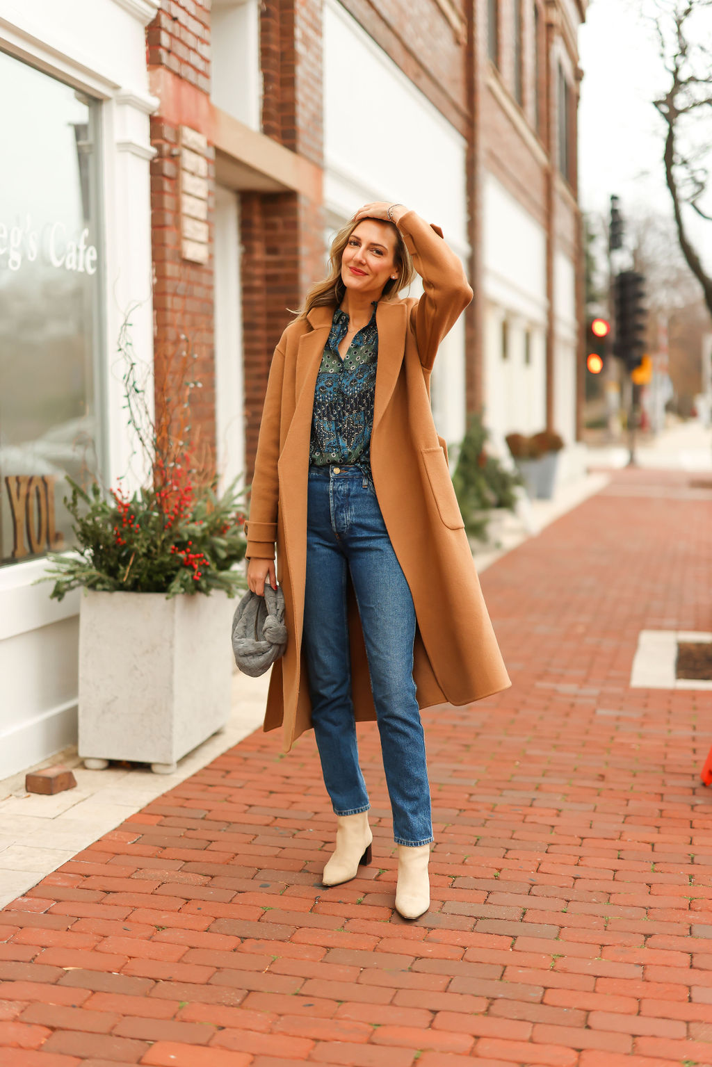 woman wearing printed top, pants, and coat from Sézane