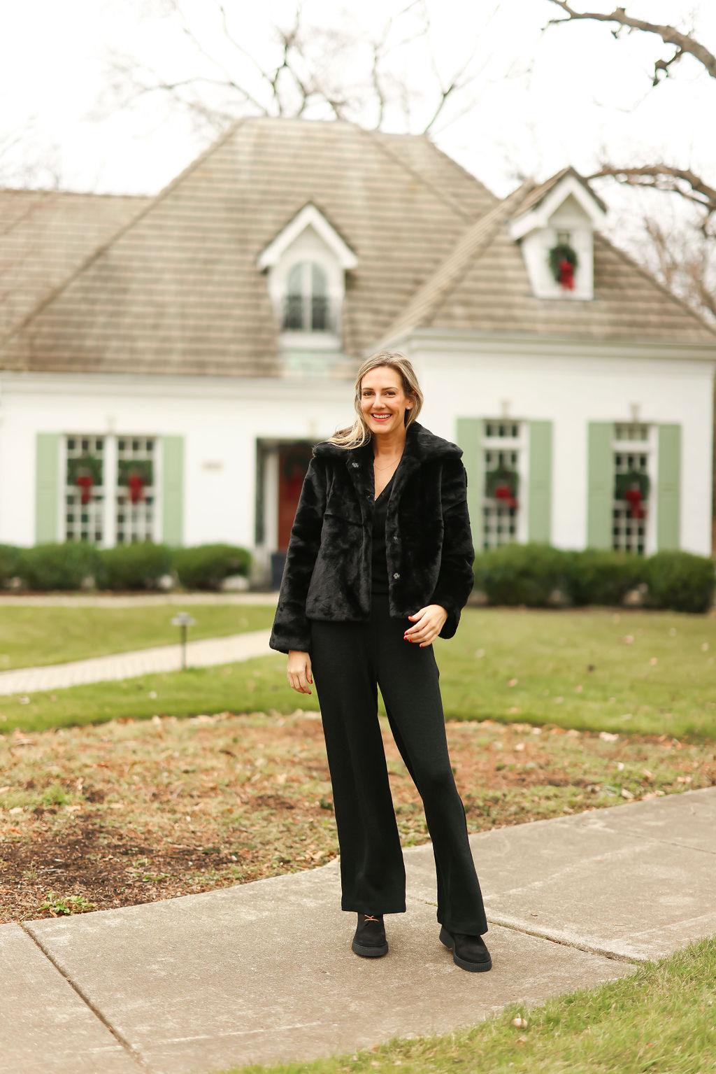 woman standing outside a house