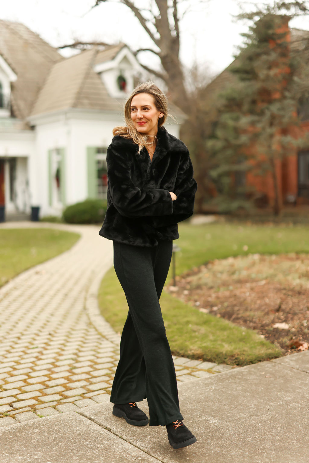 woman Getting Cozy in her all black outfit