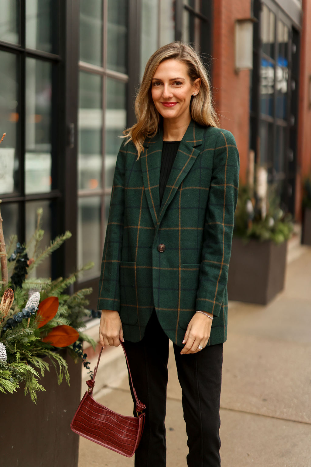 woman smiling and wearing black top, black bottom and sweater from Style with Madewell