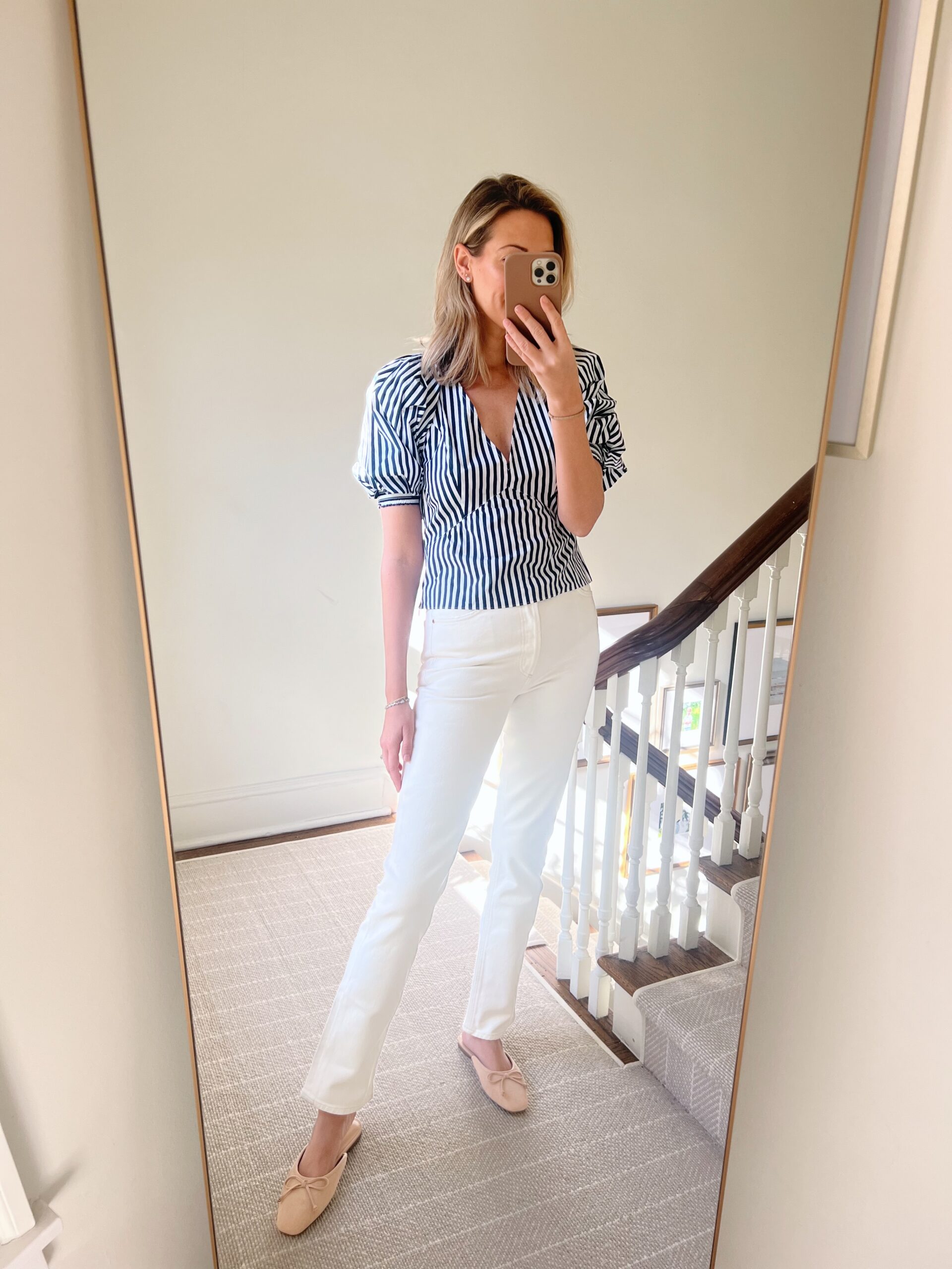woman wearing striped top and white pants