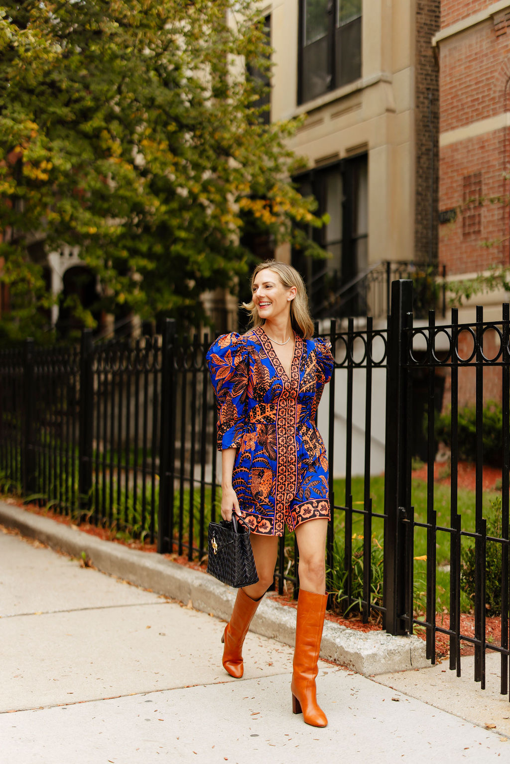 Anna Jane wearing a fun fall dress from Farm Rio Puff-Sleeve Printed Mini Dress in Blue Motif with tall brown riding boots
